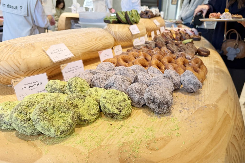 Assorted donuts including matcha, chocolate, and glazed varieties at I’m Donut in Jiyugaoka, Tokyo